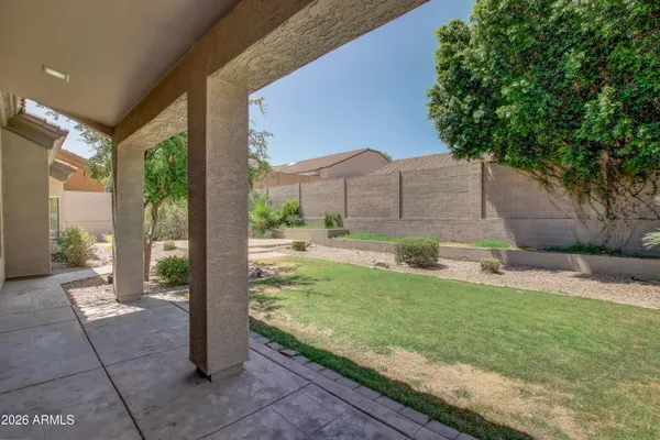 a view of a garden with a bench in patio