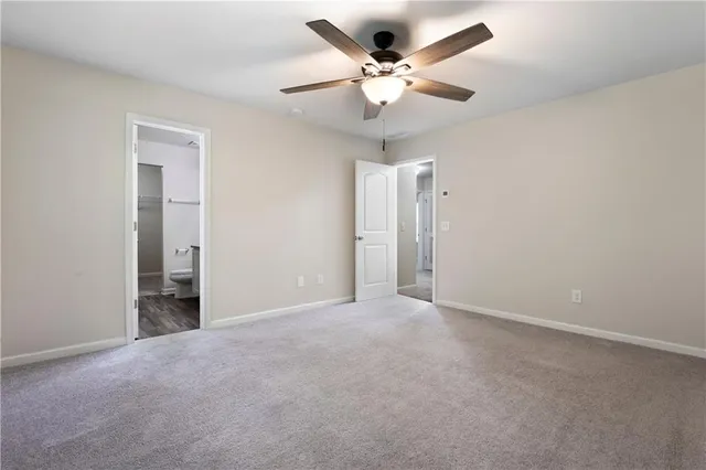 an empty room with a ceiling fan and a window