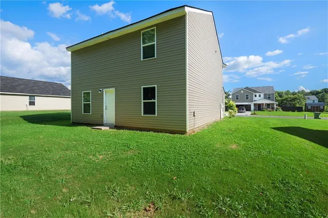 a view of a backyard with plants and a garden