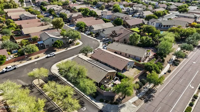 an aerial view of a house with a yard and outdoor seating