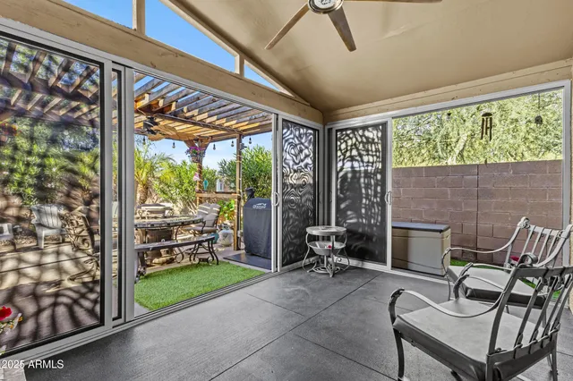 a living room with furniture and a floor to ceiling window