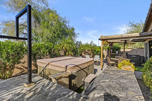 a view of a patio with table and chairs and potted plants