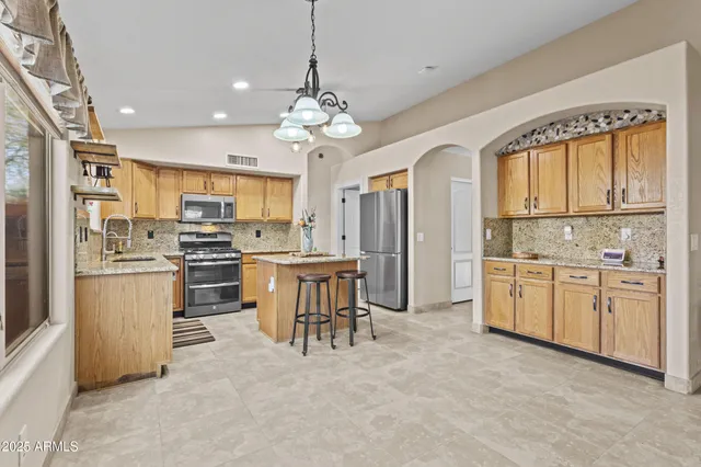 a open kitchen with white cabinets and stainless steel appliances