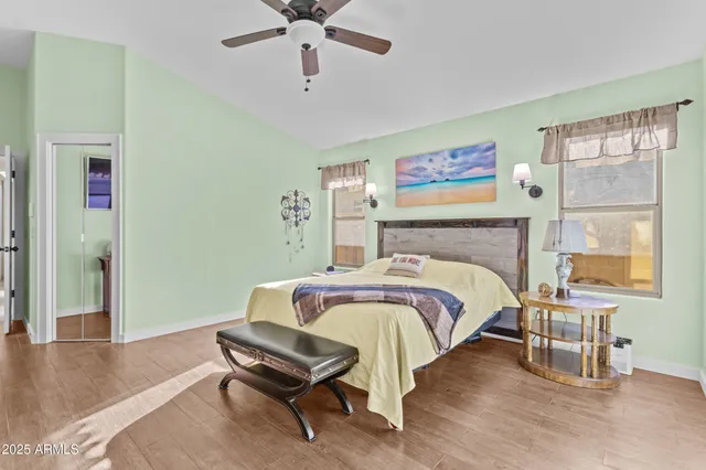 a bedroom with a bed and a large window