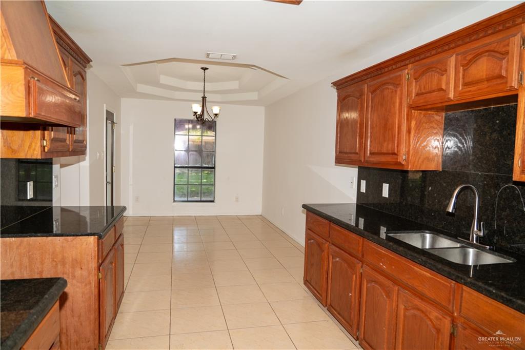 2009 Roman Street Mission, TX 78573 - Photo 15 of 22 a kitchen with stainless steel appliances granite countertop a sink stove and cabinets