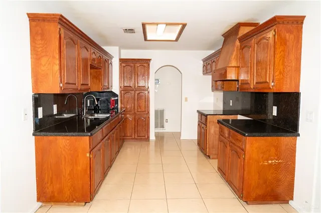 a kitchen with granite countertop a stove and a refrigerator