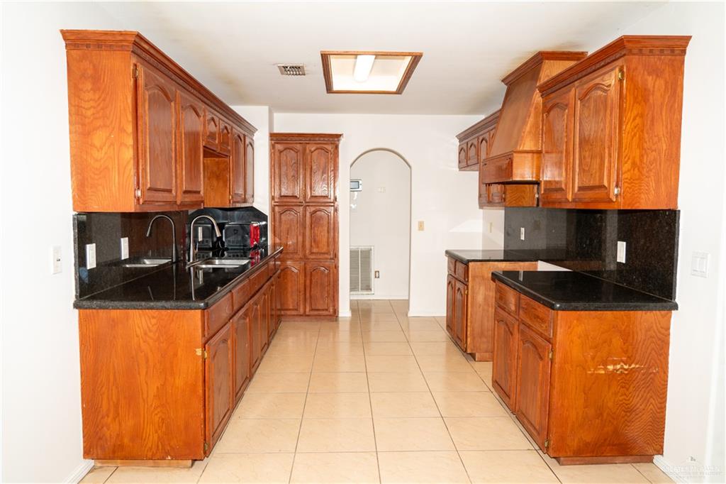 2009 Roman Street Mission, TX 78573 - Photo 16 of 22 a kitchen with granite countertop a stove and a refrigerator