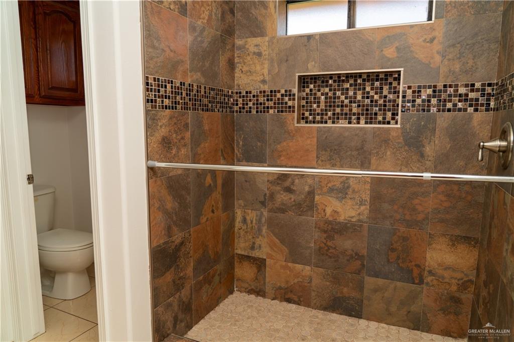 2009 Roman Street Mission, TX 78573 - Photo 20 of 22 a bathroom with a toilet and a shower