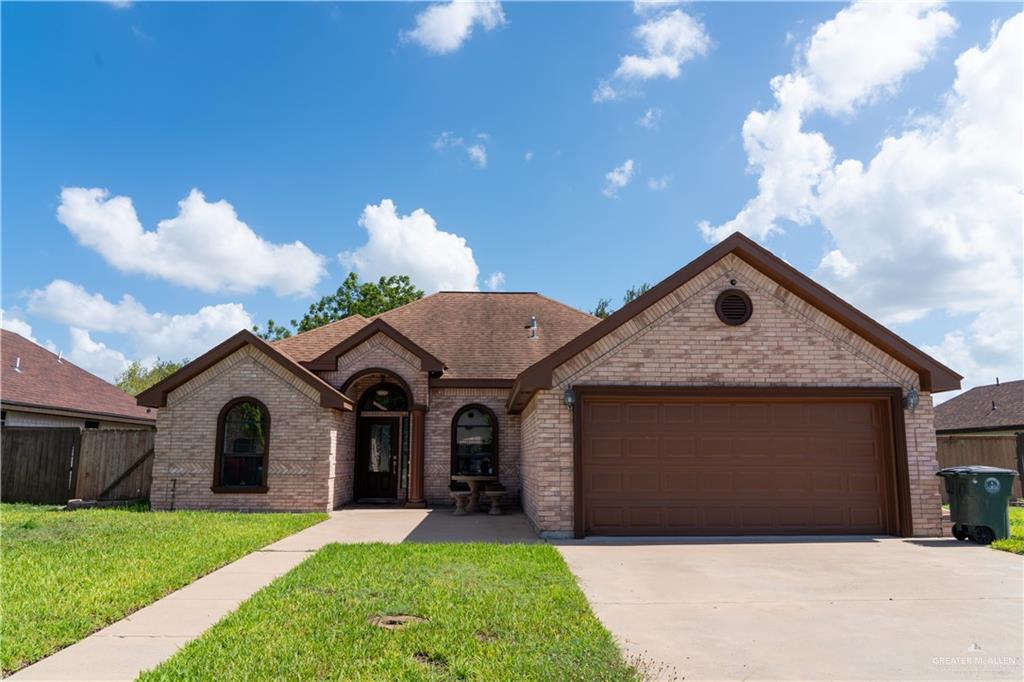 2009 Roman Street Mission, TX 78573 - Photo 2 of 22 a front view of a house with a yard and garage
