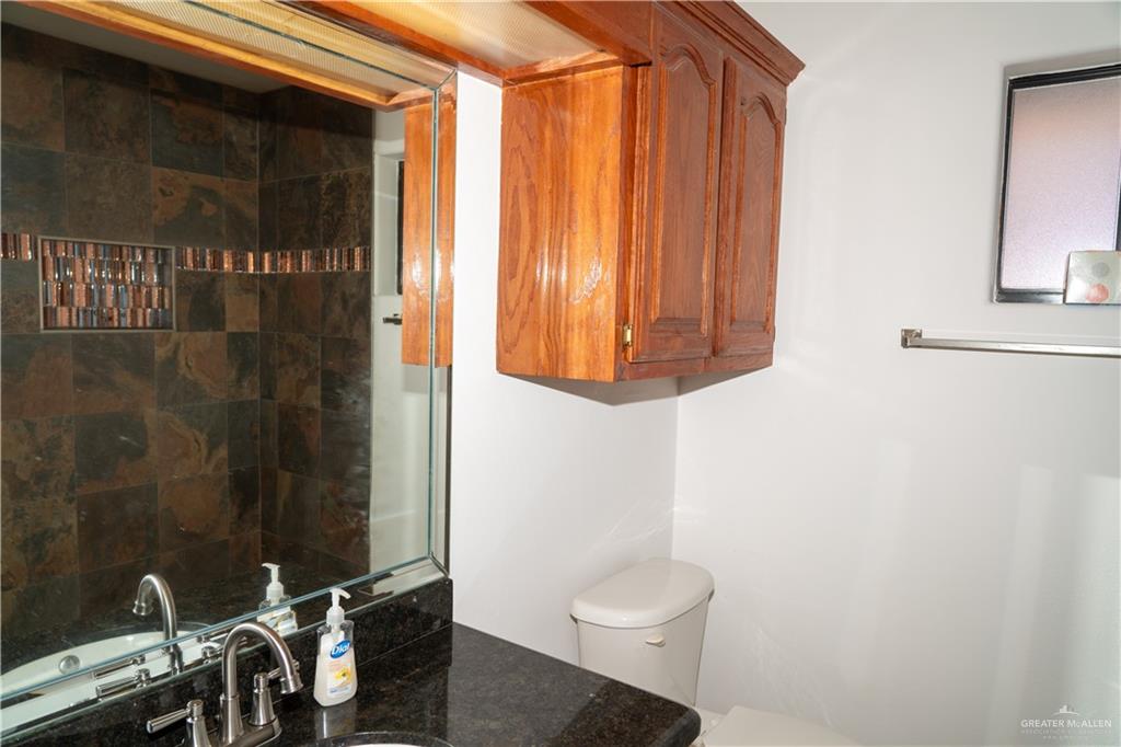 2009 Roman Street Mission, TX 78573 - Photo 22 of 22 a bathroom with a toilet a sink and shower