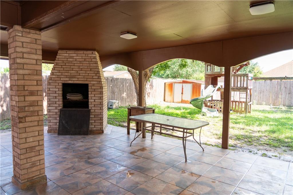 2009 Roman Street Mission, TX 78573 - Photo 5 of 22 a living room with furniture a window and a fireplace