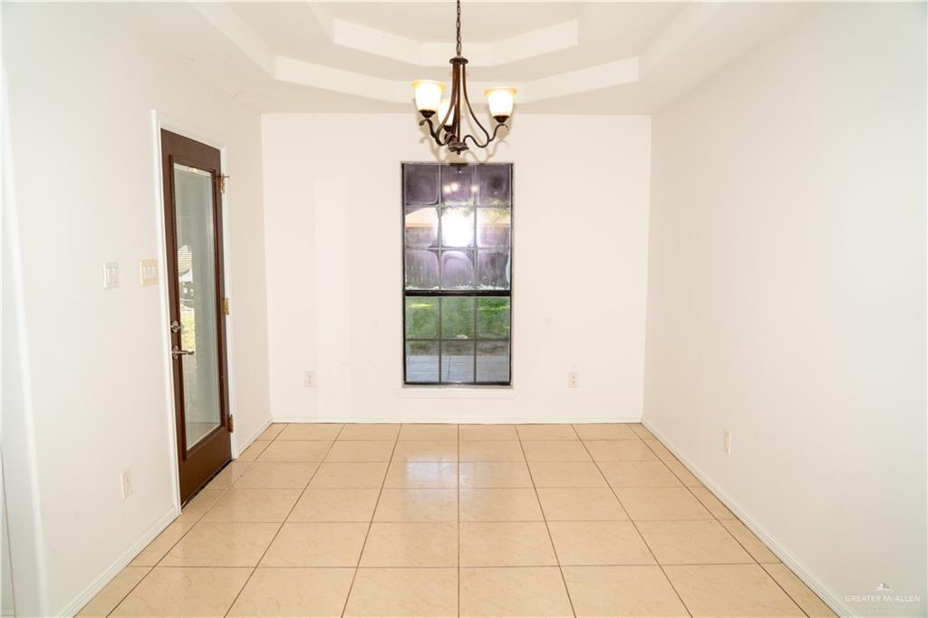 2009 Roman Street Mission, TX 78573 - Photo 9 of 22 a view of a room with a chandelier and refrigerator