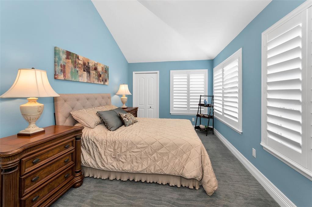 13303 Gulf Lane Madeira Beach, FL 33708 - Photo 24 of 42 a bedroom with a bed and a large window