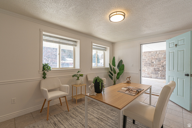 1045 Fox Farm Road Logan, UT 84321 - Photo 15 of 65 Dining area with a textured ceiling and crown molding