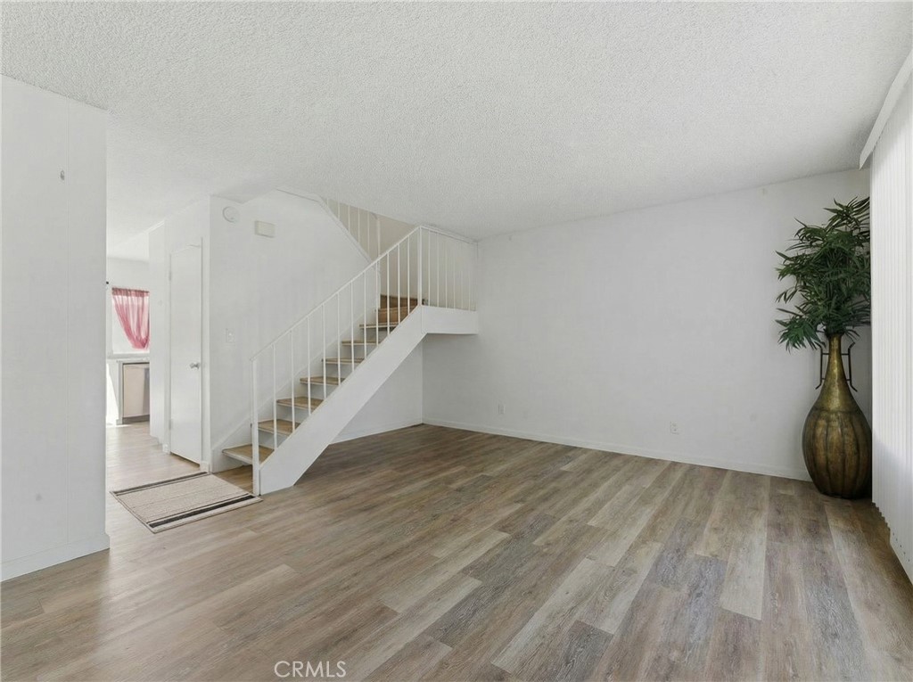 7085 Fulton Way Stanton, CA 90680 - Photo 13 of 34 a view of entryway and hall with wooden floor