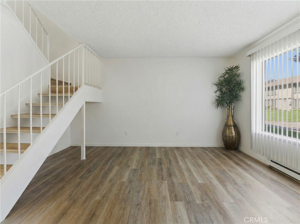 7085 Fulton Way Stanton, CA 90680 - Photo 14 of 34 a view of an empty room with stairs and a window