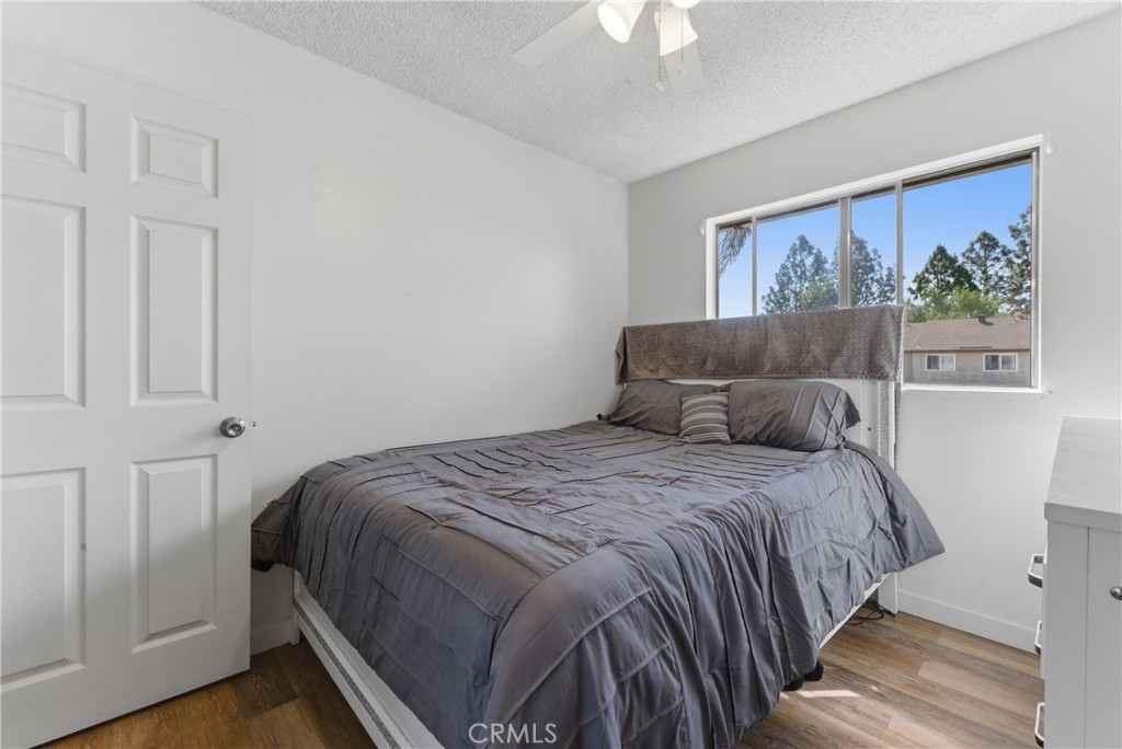 7085 Fulton Way Stanton, CA 90680 - Photo 16 of 34 a bedroom with a bed and a painting on the wall