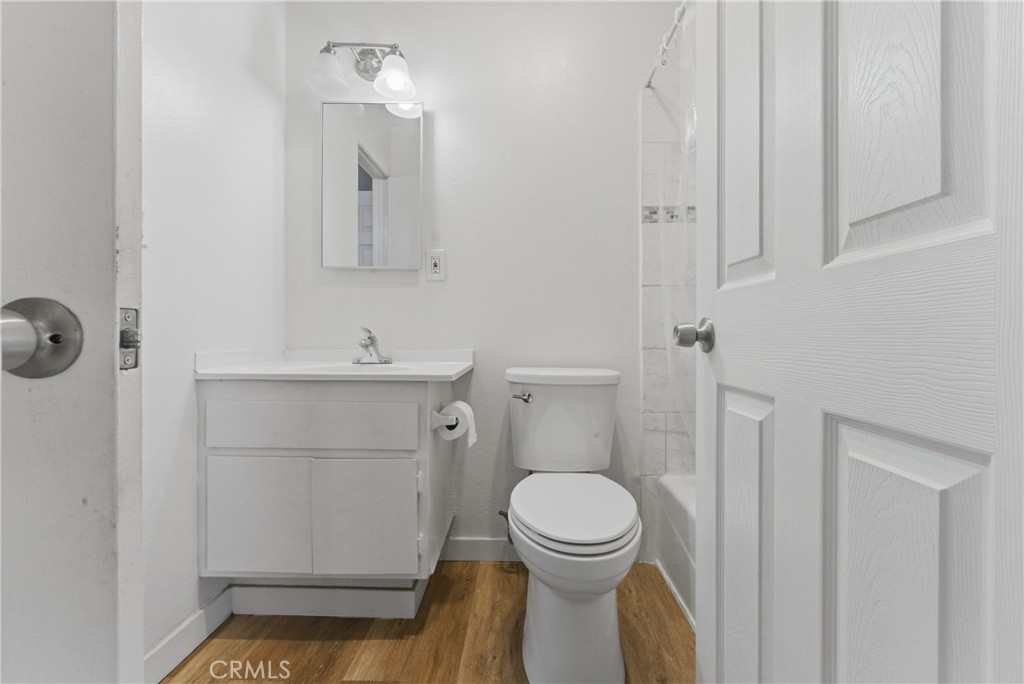 7085 Fulton Way Stanton, CA 90680 - Photo 22 of 34 a bathroom with a toilet sink and mirror