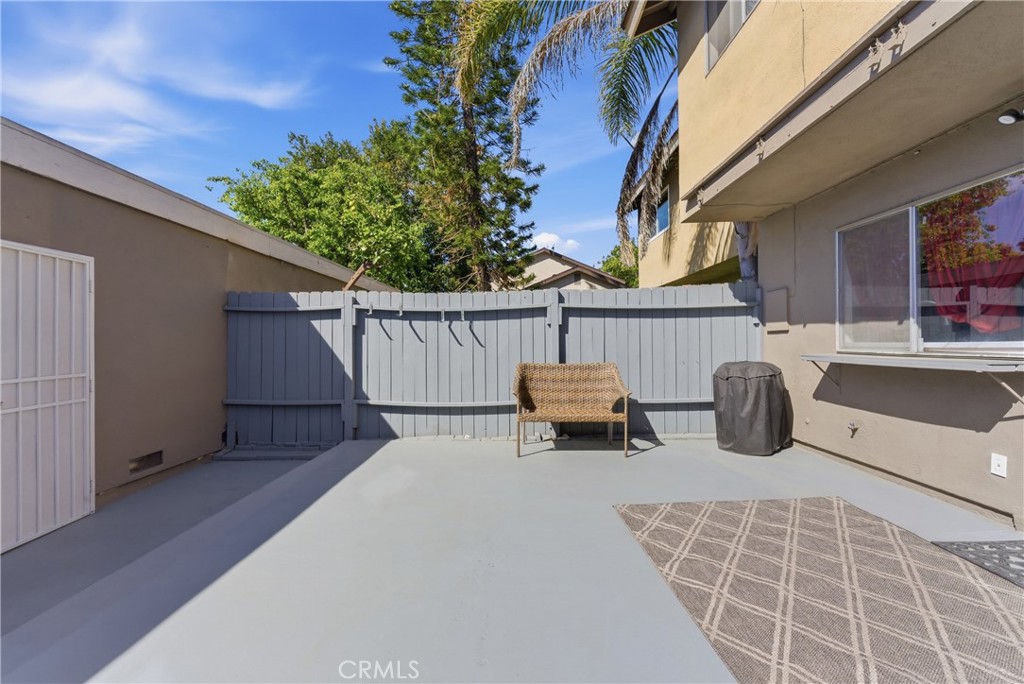 7085 Fulton Way Stanton, CA 90680 - Photo 25 of 34 a view of a patio with table and chairs with wooden fence and plants