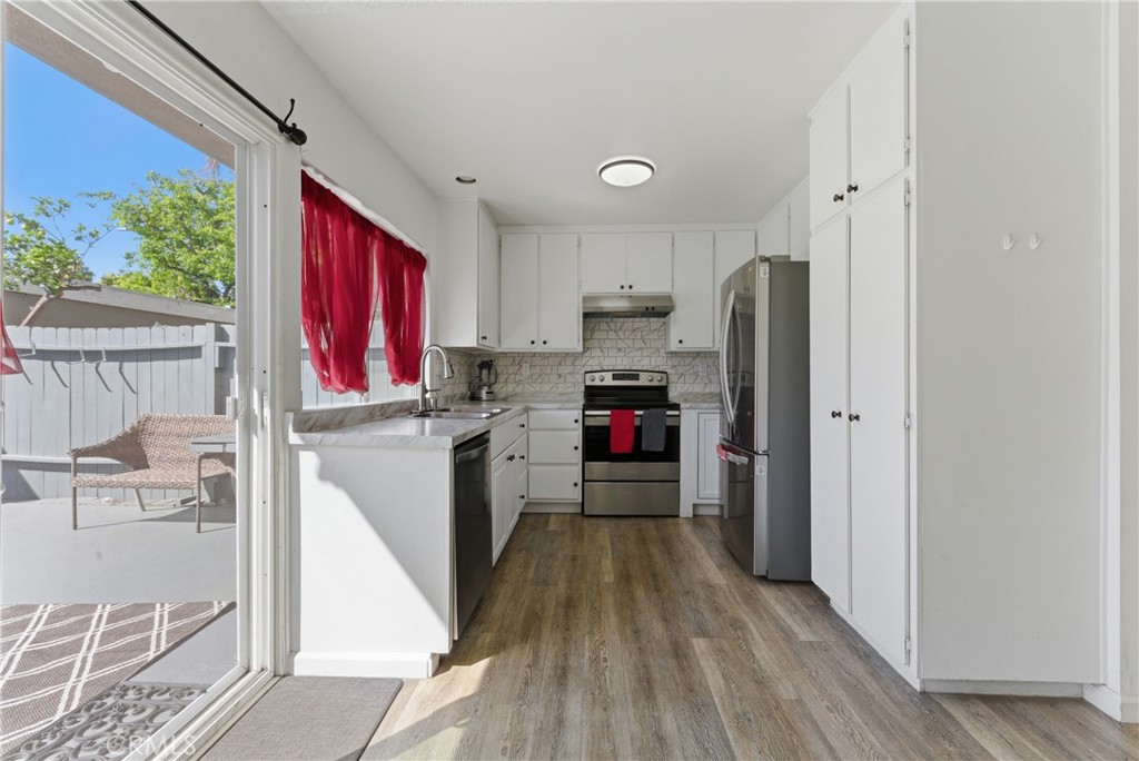 7085 Fulton Way Stanton, CA 90680 - Photo 4 of 34 a kitchen with refrigerator a stove a sink and a window