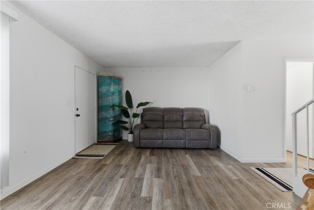 7085 Fulton Way Stanton, CA 90680 - Photo 10 of 34 a room with furniture and a wooden floor