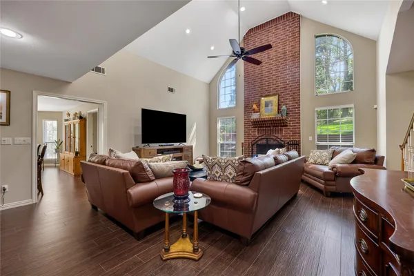 a living room with furniture fireplace and a flat screen tv