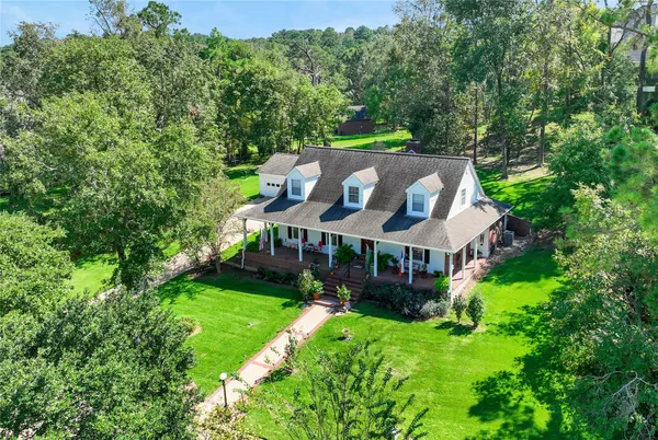 an aerial view of a house with a big yard