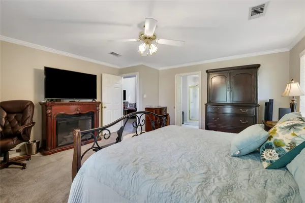 a bedroom with a bed and a flat tv screen on wall