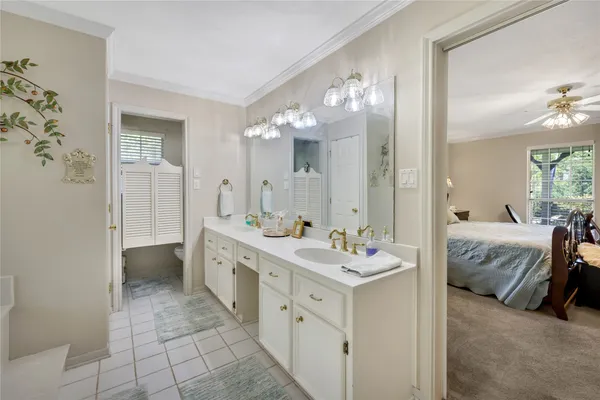 a spacious en suite bathroom with a double vanity sink and a mirror