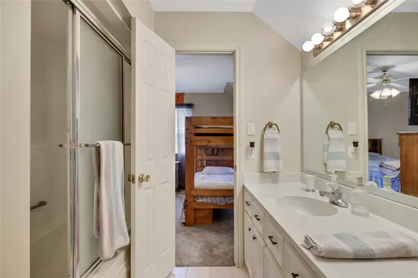 a en suite bathroom with a double vanity sink and a mirror