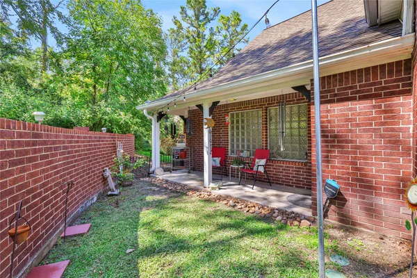 a view of a chair and table in backyard of the house