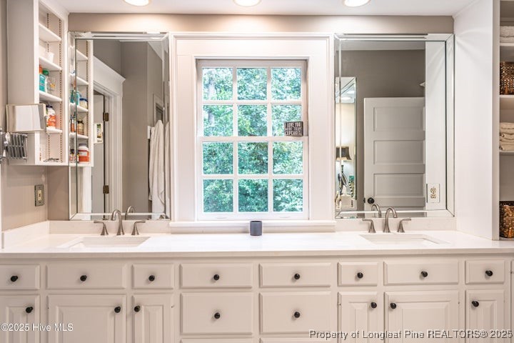 11102 Old Johns Road Laurinburg, NC 28352 - Photo 21 of 42 a bathroom with sink mirror and window