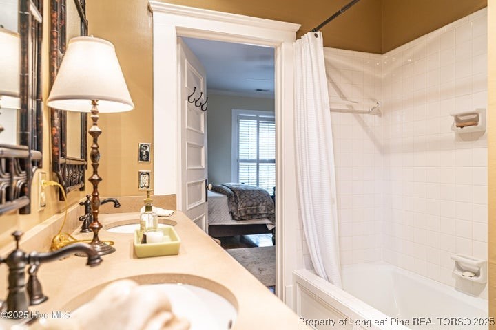 11102 Old Johns Road Laurinburg, NC 28352 - Photo 34 of 42 a en suite bathroom with a granite countertop sink and a mirror