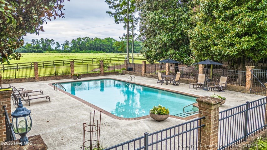 11102 Old Johns Road Laurinburg, NC 28352 - Photo 40 of 42 a view of a swimming pool with a patio and a yard