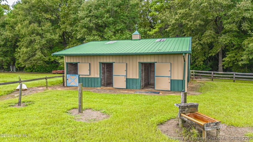 11102 Old Johns Road Laurinburg, NC 28352 - Photo 41 of 42 a backyard of a house with table and chairs