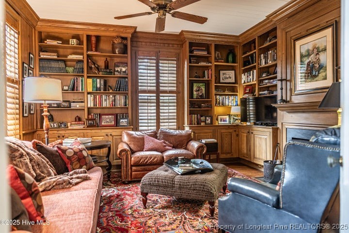 11102 Old Johns Road Laurinburg, NC 28352 - Photo 6 of 42 a living room with furniture a bookshelf and a window