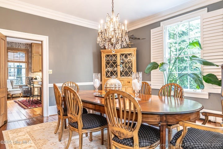 11102 Old Johns Road Laurinburg, NC 28352 - Photo 8 of 42 a dining room with furniture a large window and a chandelier