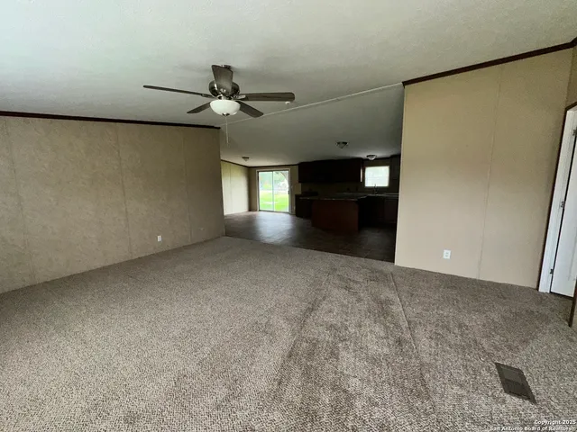 an empty room with a empty space and a ceiling fan