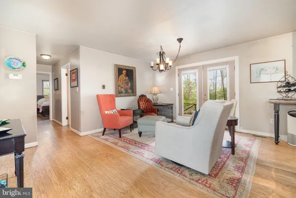 a kitchen with stainless steel appliances kitchen island granite countertop a table chairs and a refrigerator