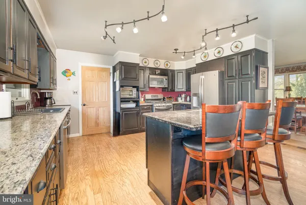 a dining room with furniture and wooden floor