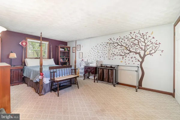 a view of room with hardwood floor and fan