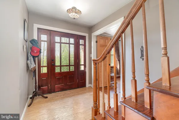 a living room with furniture and a book shelf