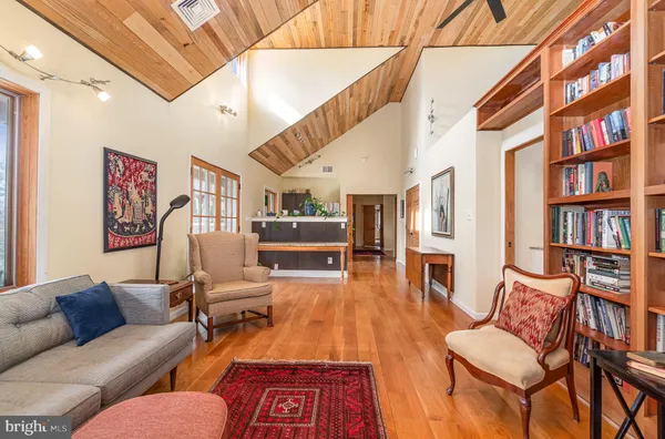 a living room with furniture a rug and a large window