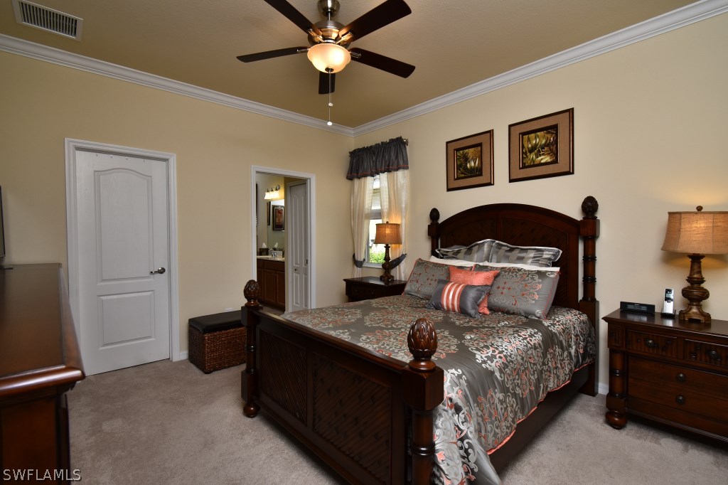 11674 Eros Road Lehigh Acres, FL 33971 - Photo 12 of 35 a bedroom with a bed and wooden floor