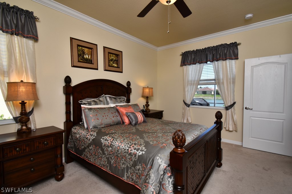11674 Eros Road Lehigh Acres, FL 33971 - Photo 13 of 35 a bedroom with a bed and a dresser