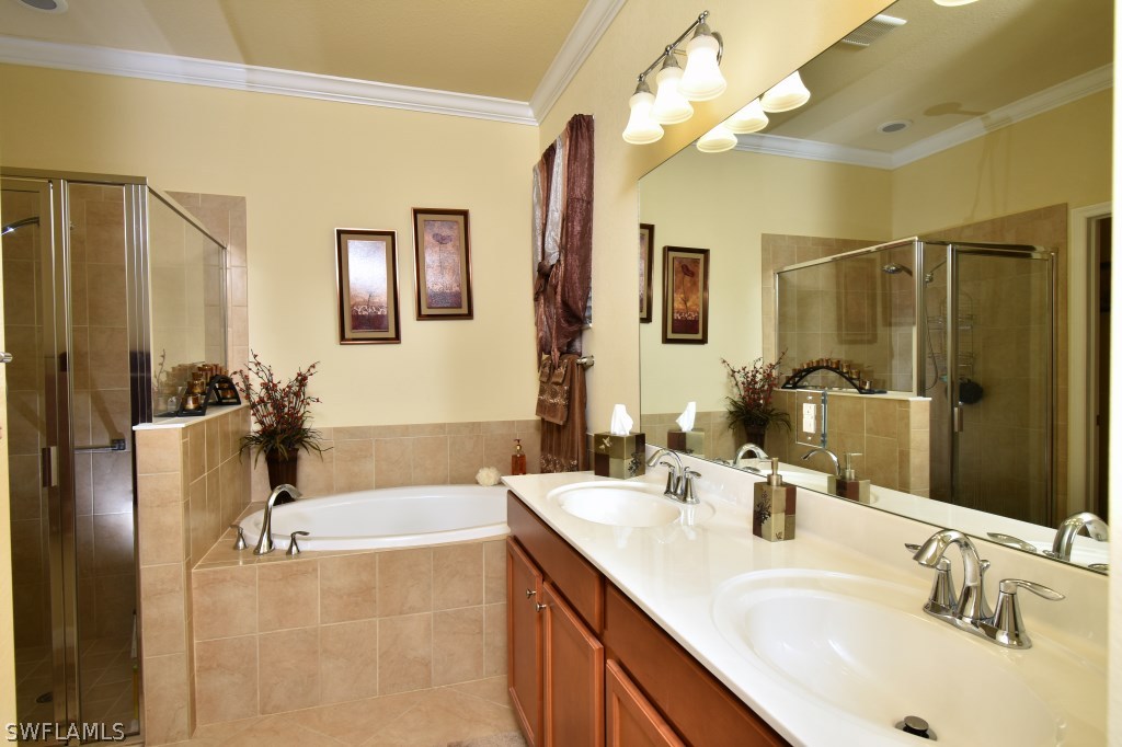 11674 Eros Road Lehigh Acres, FL 33971 - Photo 15 of 35 a bathroom with a tub sink and mirror