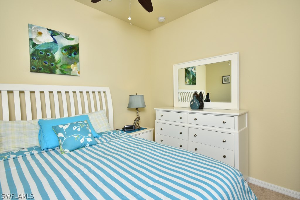 11674 Eros Road Lehigh Acres, FL 33971 - Photo 17 of 35 a bedroom with a bed and a dresser