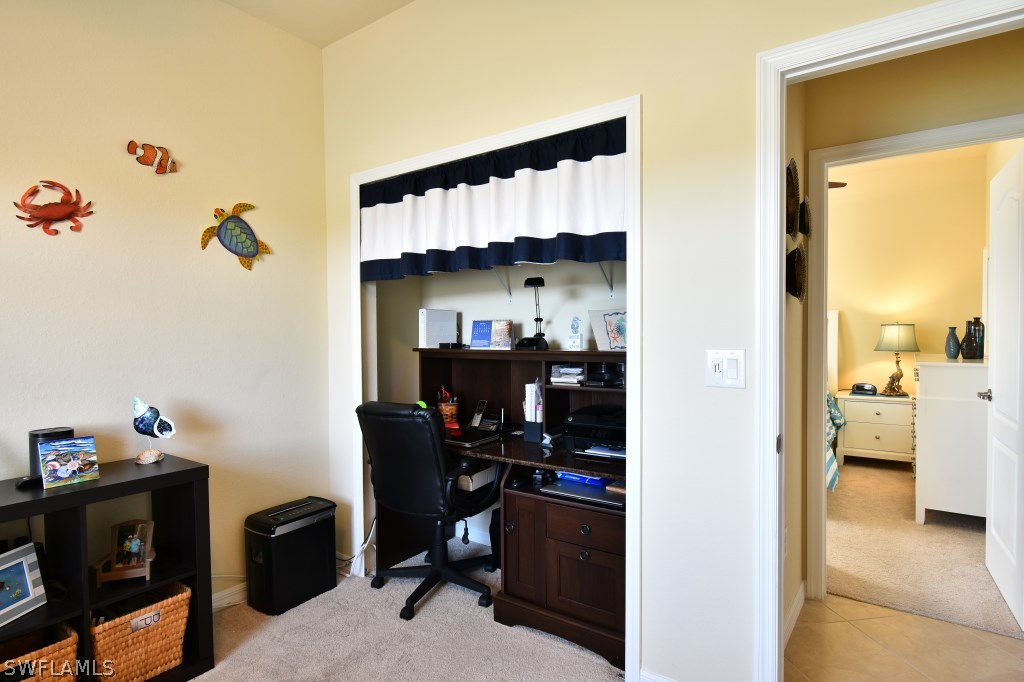 11674 Eros Road Lehigh Acres, FL 33971 - Photo 20 of 35 a view of a workspace with furniture and a window