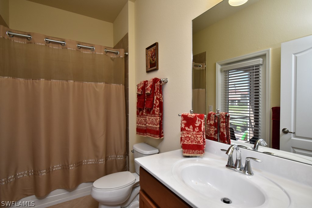11674 Eros Road Lehigh Acres, FL 33971 - Photo 21 of 35 a bathroom with a sink toilet and shower
