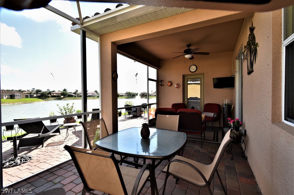 11674 Eros Road Lehigh Acres, FL 33971 - Photo 23 of 35 a living room with patio furniture and a fireplace